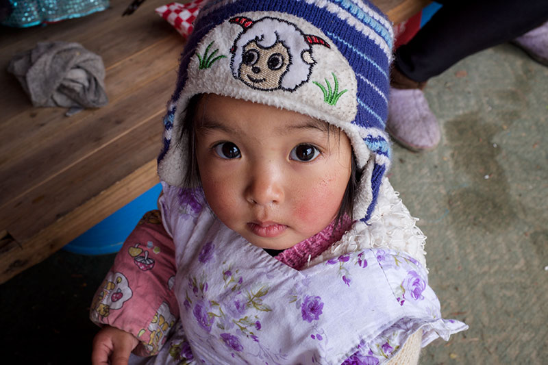 Child in ram hat